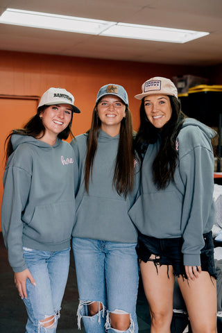 Honeys in the store wearing the SRM hats and hoodies